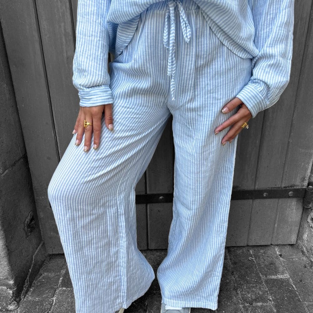 Pantalon rayé pascale de couleur bleu et blanc vue de face et porté par une femme